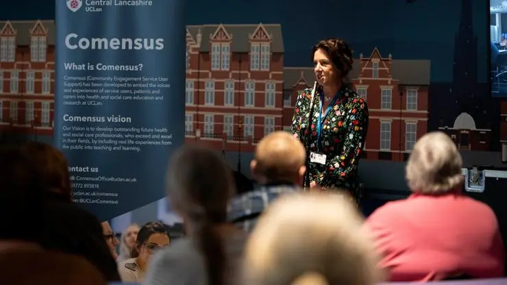 Comensus staff delivering a talk.