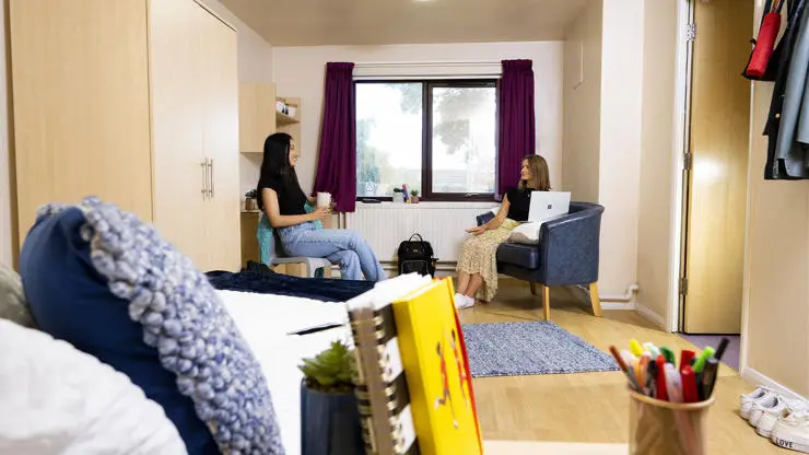 Students sat talking in a flat