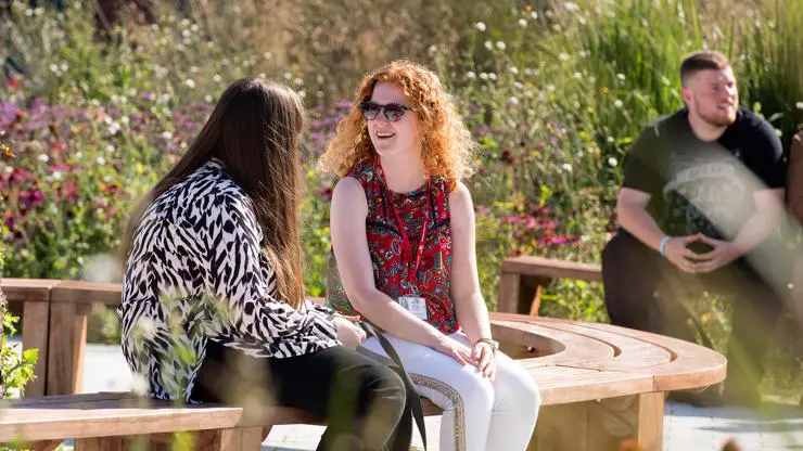 Students enjoying an outdoor social space on our Preston Campus