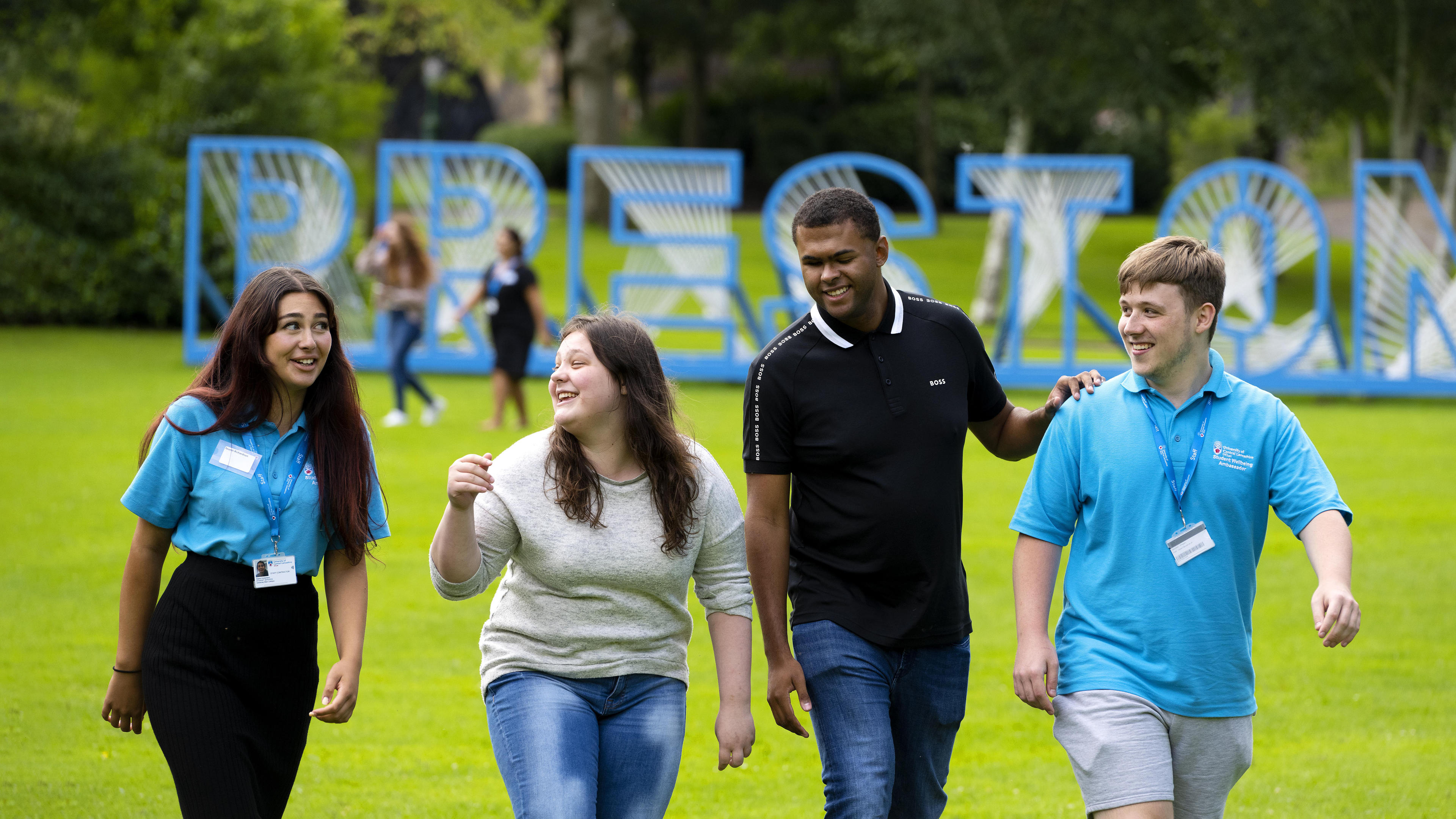 A group of STAR attendees and wellbeing ambassadors walking through a park in Preston