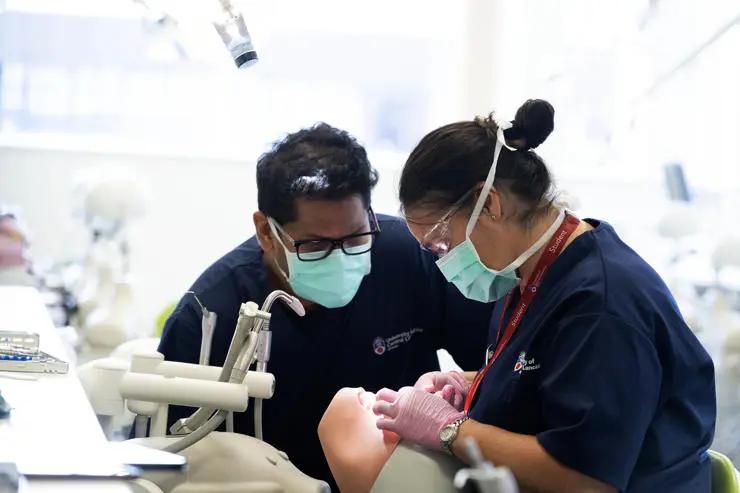 BDSi students are seen working on a doll