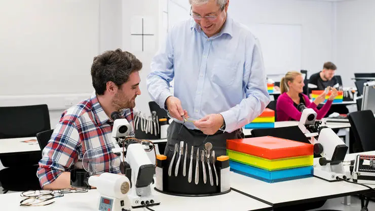 Student working under guidance from academic