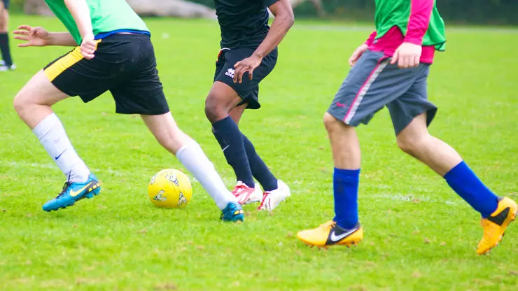 Football coaches work with teams to improve performance.