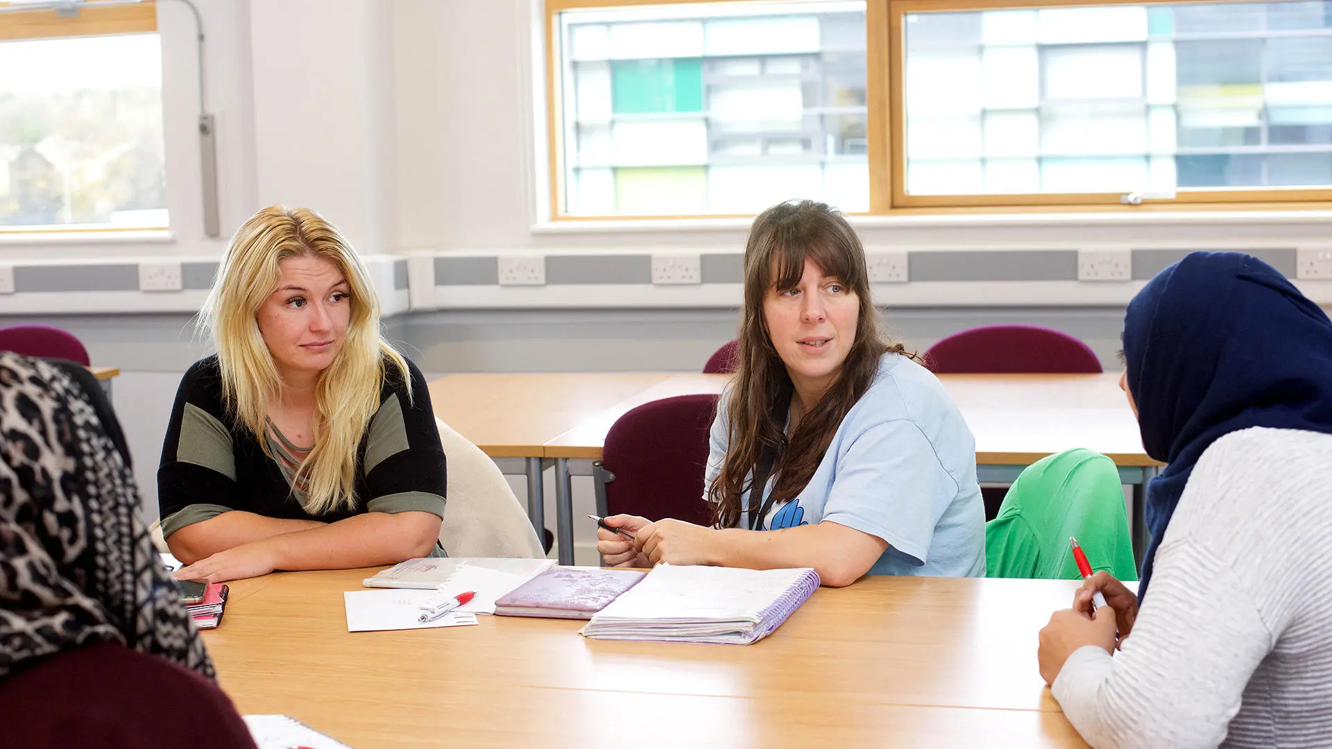 students sat around a table talking
