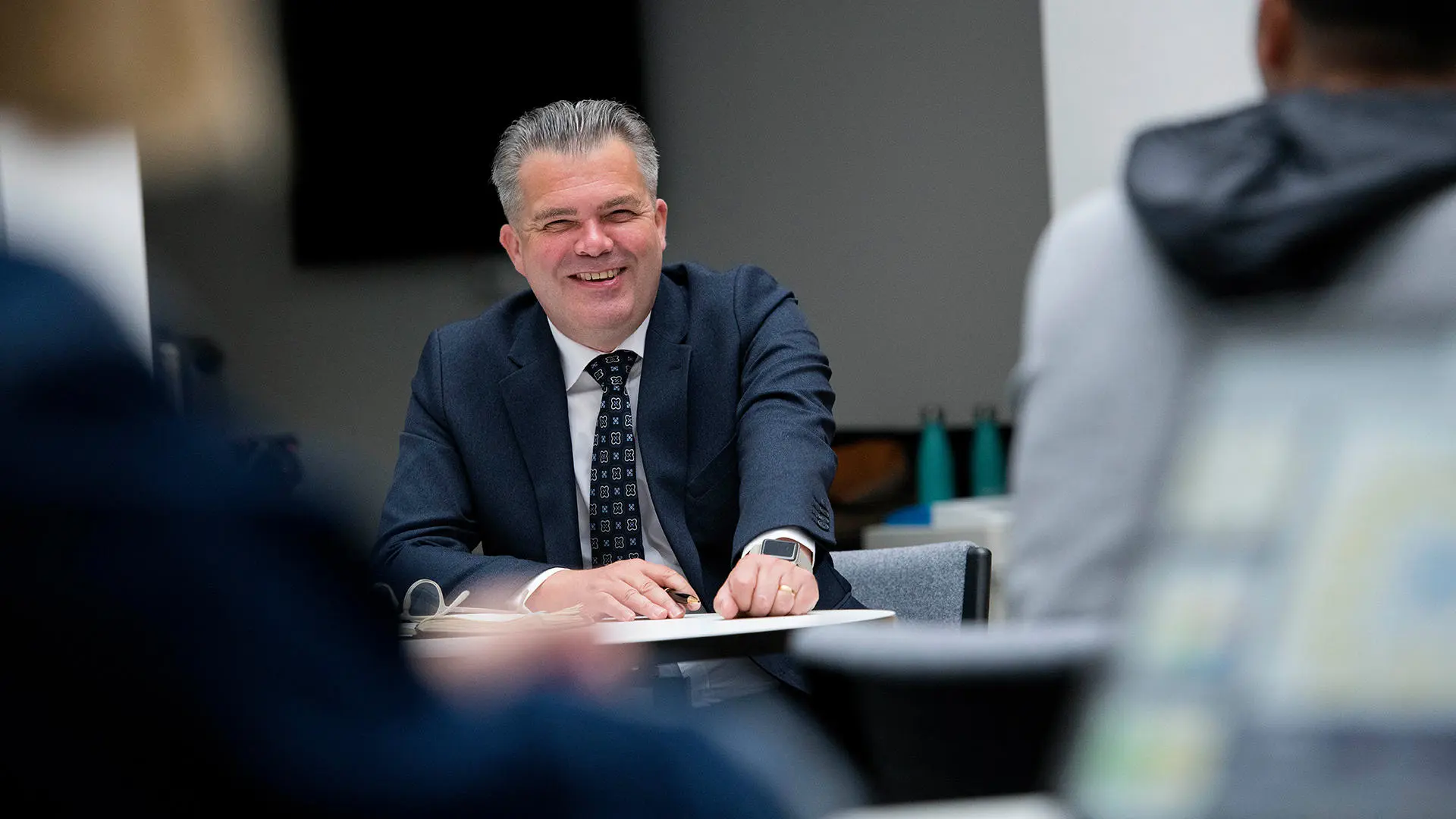 person in suit smiling