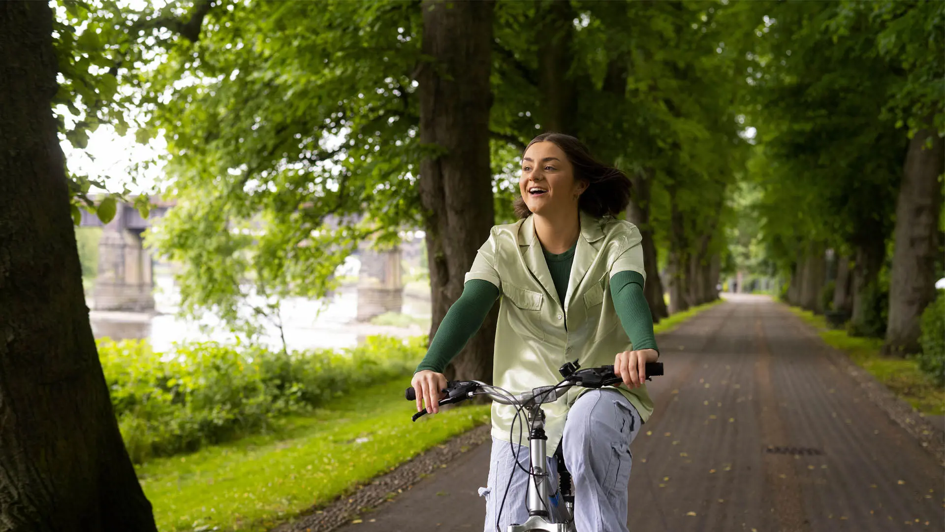 student riding a bike through avenham park