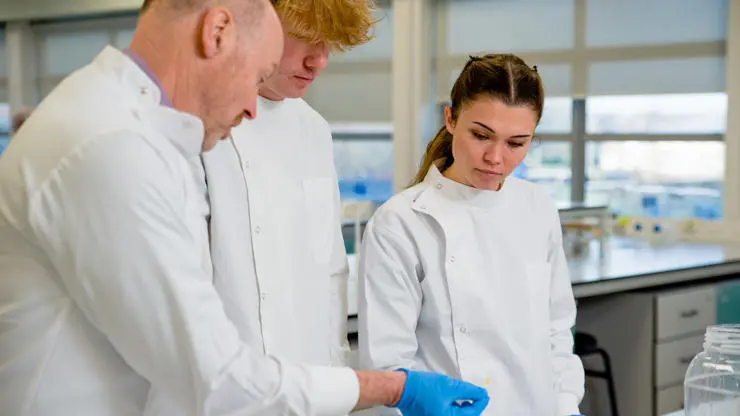 Students being taught by a lecturer in a lab