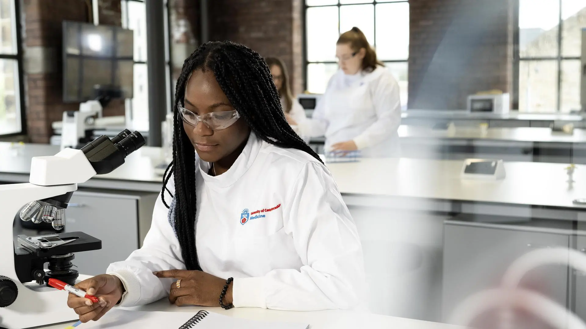 A research student working in a lab.