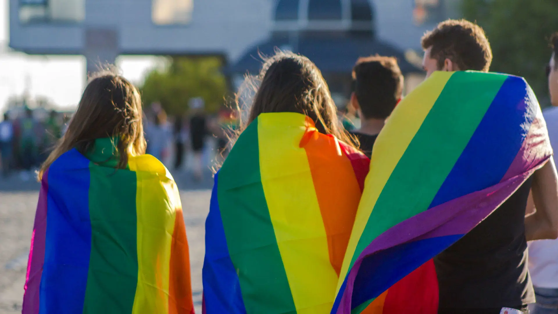 People at pride wearing pride flags
