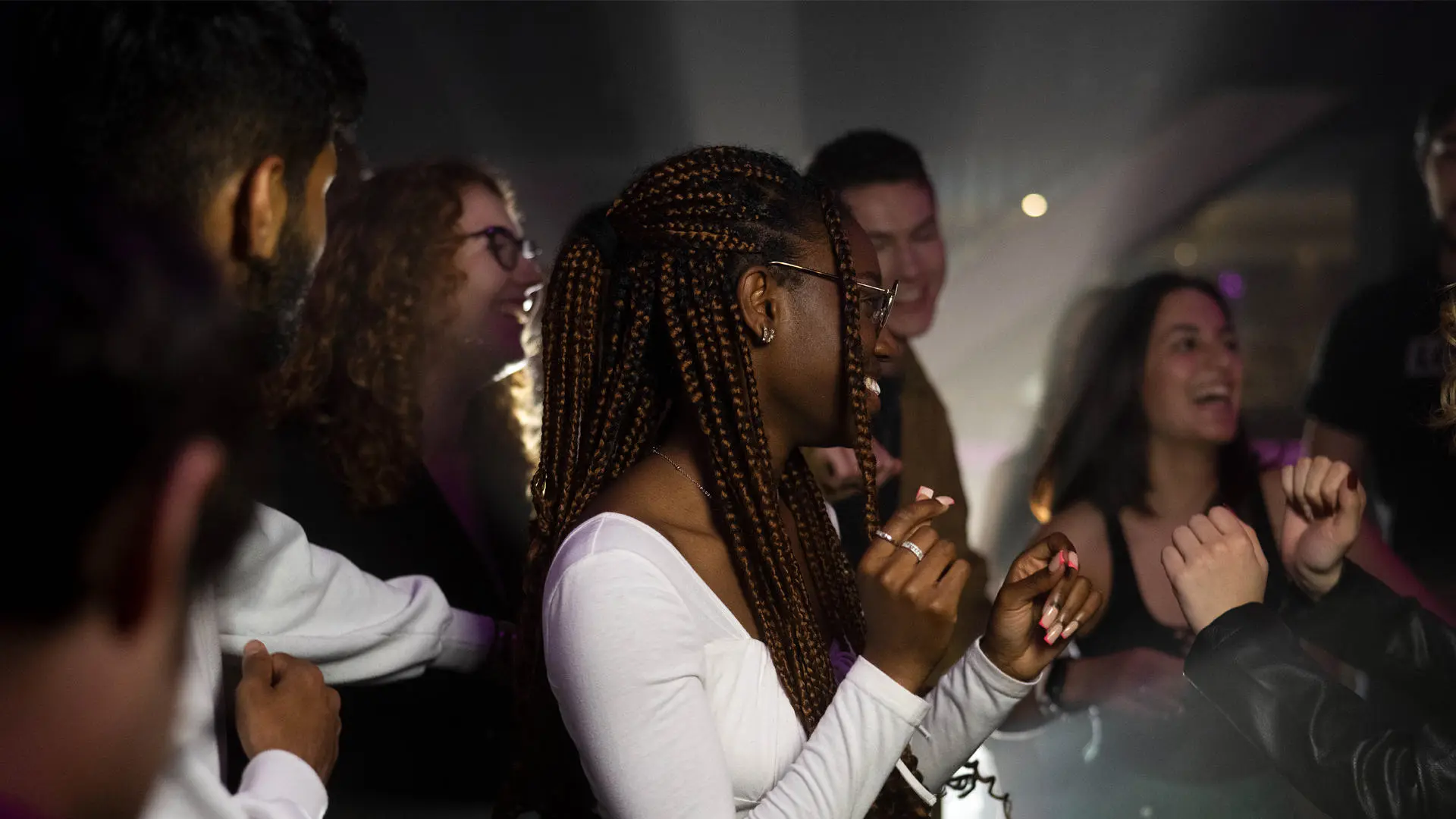 group of students dancing in a club
