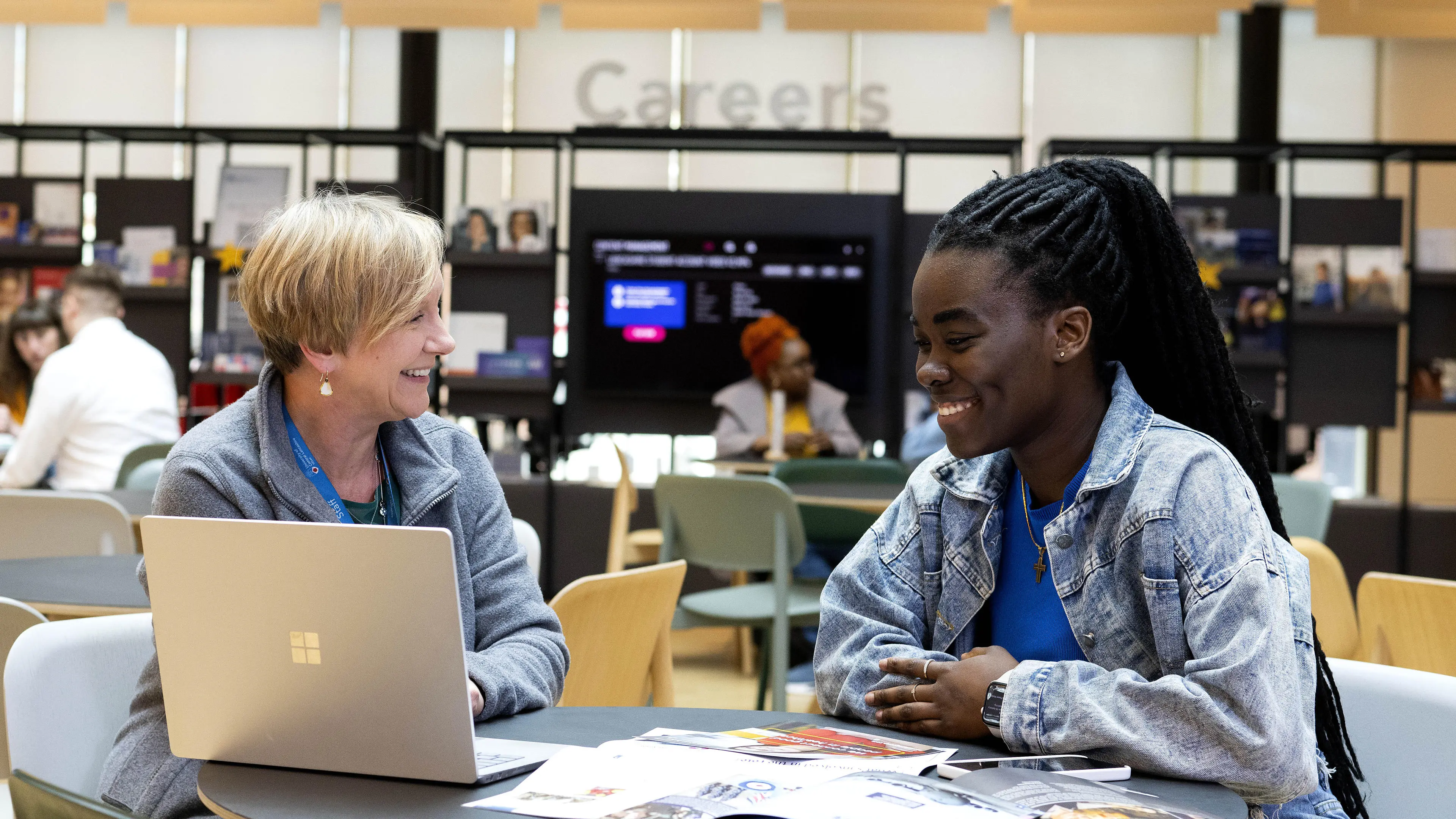 A careers adviser giving support to a student