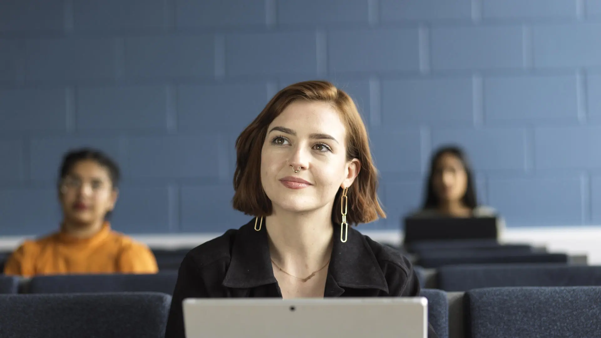 Three students sat in a lecture