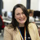 member of staff yvie smiling at her desk