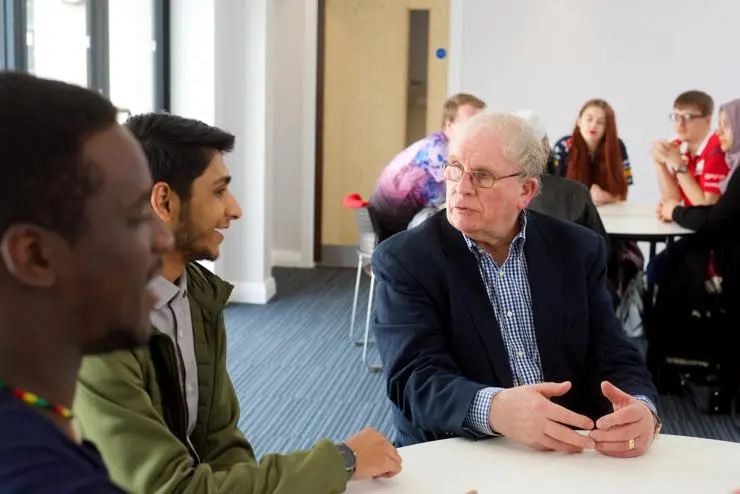 Chaplain talking to students
