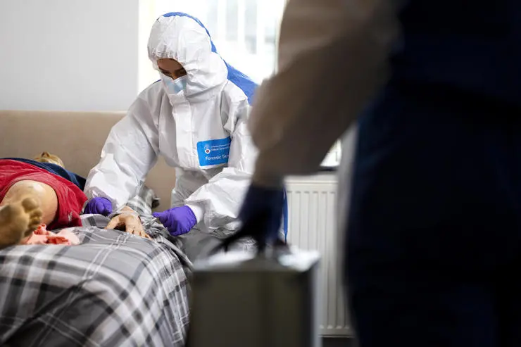 Collecting fibre samples from a dummy in a bedroom